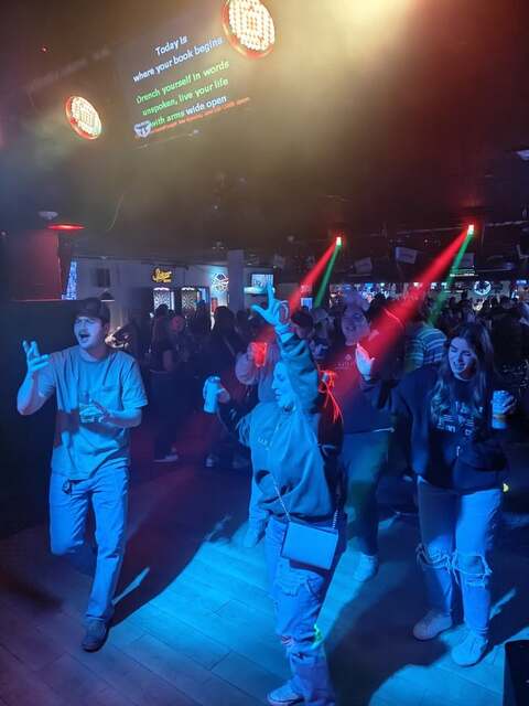 Guests dancing under the lights during karaoke night